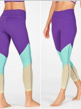 Fabletics Zone High-Waisted 7/8 Leggings in a purple, aqua, and yellow 3X